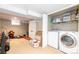 Bright laundry room featuring updated washer and dryer with shelving and ample space at 3182 W 29Th Ave, Denver, CO 80211