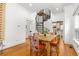 Open living area with hardwood floors, dining table, and unique spiral staircase at 3182 W 29Th Ave, Denver, CO 80211