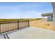 Back patio with a black metal fence and views of the open space at 4255 Gozzer Ranch Dr, Elizabeth, CO 80107