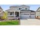 Beautiful two-story home with a covered porch, two-car garage, and freshly laid lawn at 4255 Gozzer Ranch Dr, Elizabeth, CO 80107