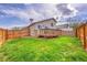 Fenced backyard features a wooden deck and a well-maintained lawn at 598 Arden Cir, Highlands Ranch, CO 80126