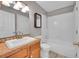Bright bathroom features tile flooring, a shower-tub combo, and a mirrored vanity at 598 Arden Cir, Highlands Ranch, CO 80126