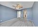 Spacious bedroom boasts blue walls, carpet, ceiling fan, and an ensuite bathroom at 598 Arden Cir, Highlands Ranch, CO 80126