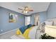Bedroom boasts blue walls, carpet, ceiling fan, and an ensuite bathroom at 598 Arden Cir, Highlands Ranch, CO 80126