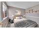 Cozy bedroom with neutral walls, carpet, and a window with natural light at 598 Arden Cir, Highlands Ranch, CO 80126