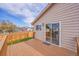 A wooden deck features a sliding glass door entrance to the house and a beautiful, sunny day at 598 Arden Cir, Highlands Ranch, CO 80126