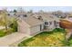 The exterior of the house includes a two-car garage, neutral-colored siding, and a green yard at 598 Arden Cir, Highlands Ranch, CO 80126