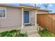 Charming front porch with a blue door, neat landscaping, and a welcoming entrance at 598 Arden Cir, Highlands Ranch, CO 80126