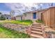 Inviting home with stone steps leading to the blue front door at 598 Arden Cir, Highlands Ranch, CO 80126