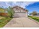 Attached two-car garage with a wide driveway at 598 Arden Cir, Highlands Ranch, CO 80126