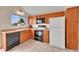 Well-lit kitchen features tile flooring, black appliances, light countertops, and wood cabinetry at 598 Arden Cir, Highlands Ranch, CO 80126