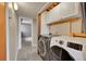 Functional laundry room with modern washer and dryer, plus extra storage cabinets for convenience at 598 Arden Cir, Highlands Ranch, CO 80126