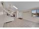 Open-concept living area with tile floors, natural light, and a view into the kitchen at 598 Arden Cir, Highlands Ranch, CO 80126
