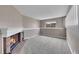 Neutral living room featuring a brick fireplace, carpeted floor, and natural light from a nearby window at 598 Arden Cir, Highlands Ranch, CO 80126
