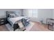 Bedroom with a queen bed, carpet, and a window for natural light at 10569 Racine St, Commerce City, CO 80022