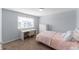 Bedroom with a twin bed, desk, dresser, and carpet flooring at 10569 Racine St, Commerce City, CO 80022
