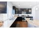 Modern kitchen with stainless steel appliances, granite countertops, and dark wood cabinetry at 10569 Racine St, Commerce City, CO 80022