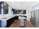 Modern kitchen with stainless steel appliances, granite countertops, and dark wood cabinetry at 10569 Racine St, Commerce City, CO 80022