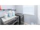 Modern laundry room with gray appliances and a bright window at 10569 Racine St, Commerce City, CO 80022