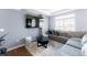 Cozy living room with large windows, a comfortable sofa, and modern decor at 10569 Racine St, Commerce City, CO 80022