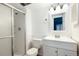 Well-lit bathroom featuring a shower, toilet, and vanity with a mirror at 18103 E Kentucky Ave # 103, Aurora, CO 80017