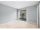 Bedroom with closet, neutral carpet, and a sliding glass door leading to the outside at 18103 E Kentucky Ave # 103, Aurora, CO 80017