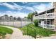 Apartment building exterior with tennis court and green space at 18103 E Kentucky Ave # 103, Aurora, CO 80017