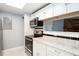 Kitchen with granite countertops, stainless steel appliances, and breakfast bar at 18103 E Kentucky Ave # 103, Aurora, CO 80017