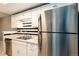 Modern kitchen with white cabinets, stainless steel appliances, and attractive black and white backsplash at 18103 E Kentucky Ave # 103, Aurora, CO 80017