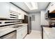 Kitchen with white cabinets, stainless steel appliances, and tile backsplash at 18103 E Kentucky Ave # 103, Aurora, CO 80017
