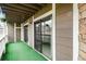 View of patio with sliding glass doors and artificial turf flooring at 18103 E Kentucky Ave # 103, Aurora, CO 80017