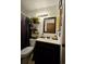 Charming bathroom with a dark vanity, stylish fixtures, and decorative accents at 2034 S Truckee St, Aurora, CO 80013