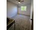 Bright, carpeted bedroom with a ceiling fan and a large window bringing in natural light at 2034 S Truckee St, Aurora, CO 80013