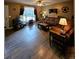 Comfortable living room with wood-look floors, television, and a side door at 2034 S Truckee St, Aurora, CO 80013