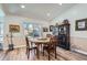 Cozy dining room with hardwood floors, a round table, and a classic built-in cabinet, creating a warm and inviting space at 11892 Vallejo St, Denver, CO 80234