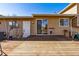 The backyard boasts a wooden deck, sliding glass doors and a door to access the home's interior at 16277 E Arkansas Dr, Aurora, CO 80017