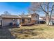The backyard features a wooden deck, grassy area and provides ample space for outdoor activities at 16277 E Arkansas Dr, Aurora, CO 80017