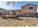 The backyard features a wooden deck, grassy area and provides ample space for outdoor activities at 16277 E Arkansas Dr, Aurora, CO 80017