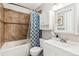 Well-lit bathroom with tub-shower, tiled walls, and vanity with ample storage at 16277 E Arkansas Dr, Aurora, CO 80017