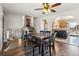 A formal dining room with modern hardwood floors, adjacent stairway, and kitchen access at 16277 E Arkansas Dr, Aurora, CO 80017