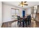 A formal dining room with modern hardwood floors, a ceiling fan, and an adjacent stairway at 16277 E Arkansas Dr, Aurora, CO 80017