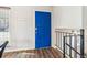 Bright entryway showcasing a vibrant blue door and modern wood flooring at 16277 E Arkansas Dr, Aurora, CO 80017