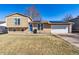 Charming two-story home featuring solar panels, a well-maintained lawn, and a attached two-car garage at 16277 E Arkansas Dr, Aurora, CO 80017