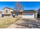 Charming two-story home with an attached two-car garage and a long driveway at 16277 E Arkansas Dr, Aurora, CO 80017