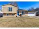 Charming two-story home featuring solar panels, a well-maintained lawn, and a bright blue front door at 16277 E Arkansas Dr, Aurora, CO 80017