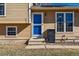 A inviting front entrance features a bright blue door with a storm door, a mailbox, and the house number at 16277 E Arkansas Dr, Aurora, CO 80017