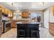 A kitchen featuring wood cabinets, stainless steel appliances, and a kitchen island at 16277 E Arkansas Dr, Aurora, CO 80017