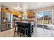 Kitchen featuring wood cabinets, stainless steel appliances and a kitchen island with seating at 16277 E Arkansas Dr, Aurora, CO 80017