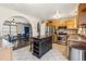 An open kitchen layout with wood cabinets, stainless steel appliances, and breakfast area at 16277 E Arkansas Dr, Aurora, CO 80017