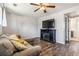 Living room with wood floors, a cozy sectional, and an electric fireplace at 16277 E Arkansas Dr, Aurora, CO 80017
